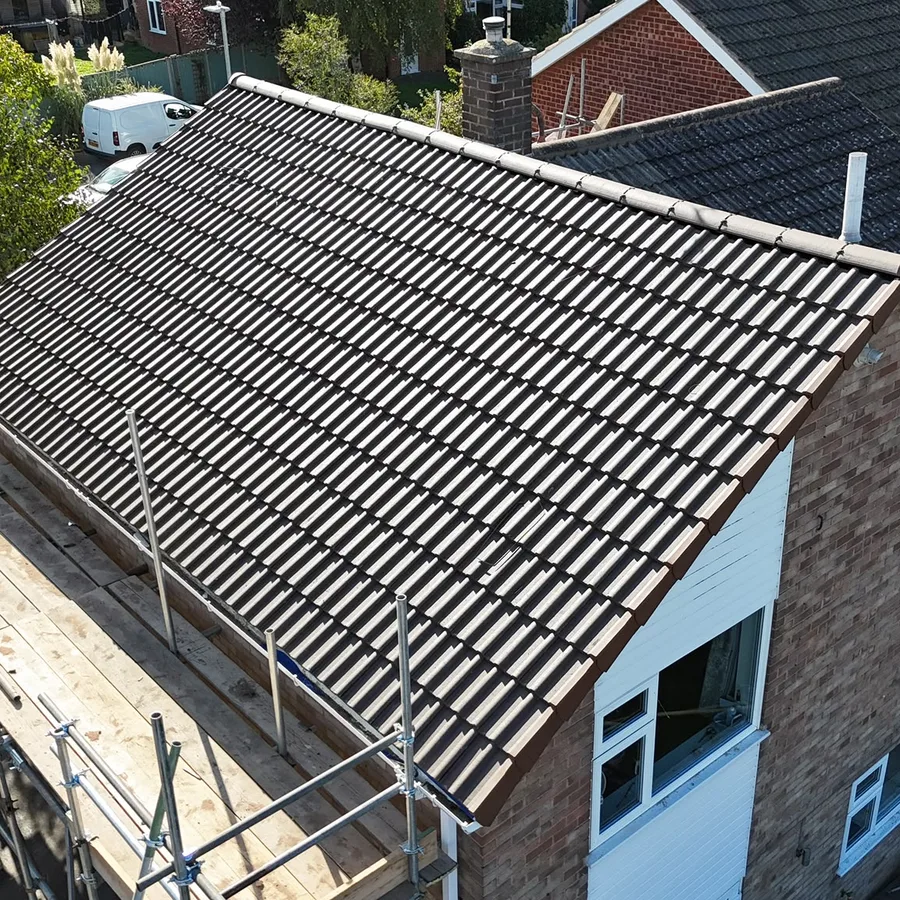 Gable roof re-covered in brown interlocking tiles