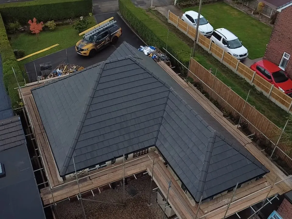 L-shaped bungalow re-roofed in grey tiles
