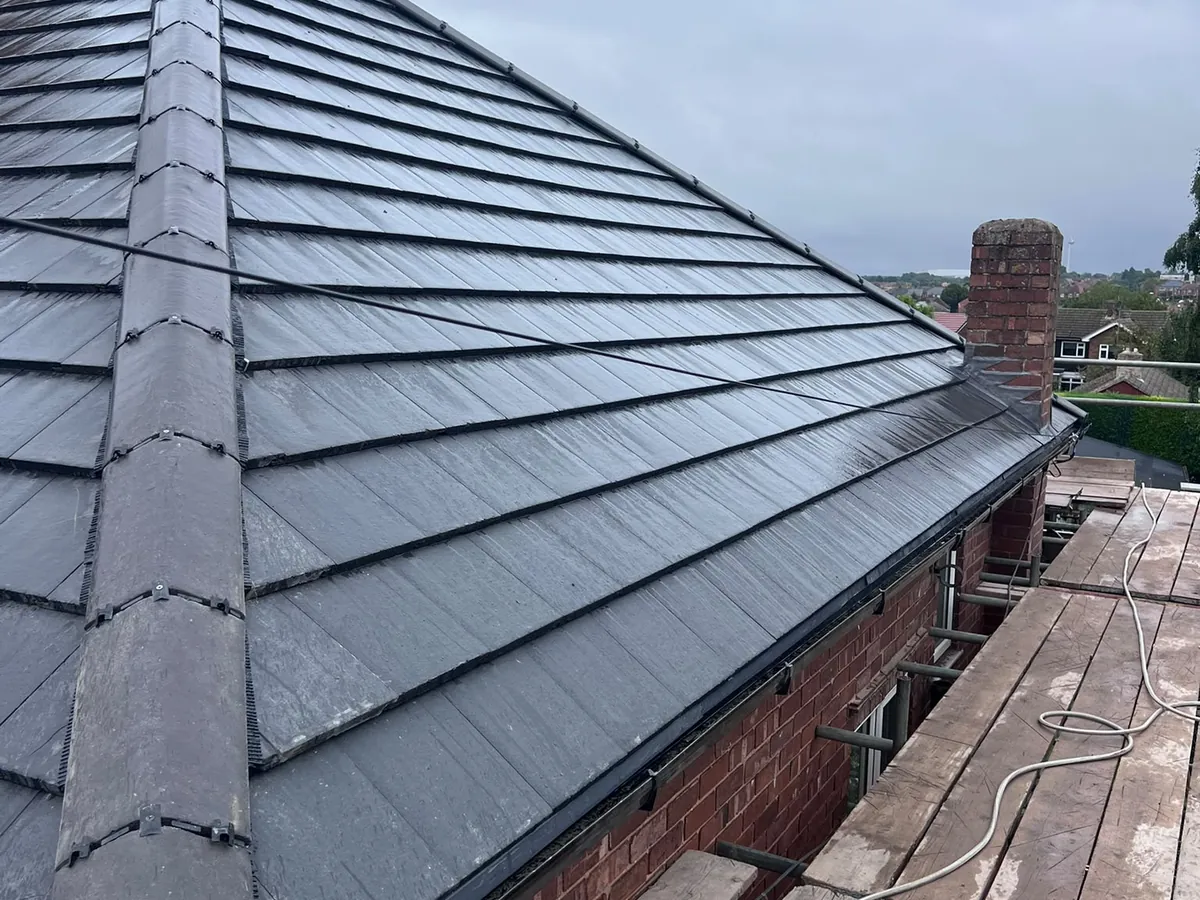 New grey tiles and dry ridge on a hipped bungalow