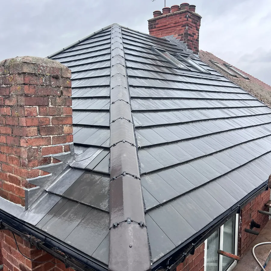Hipped roof in slate-effect tiles with a dry-fixed hip and new lead