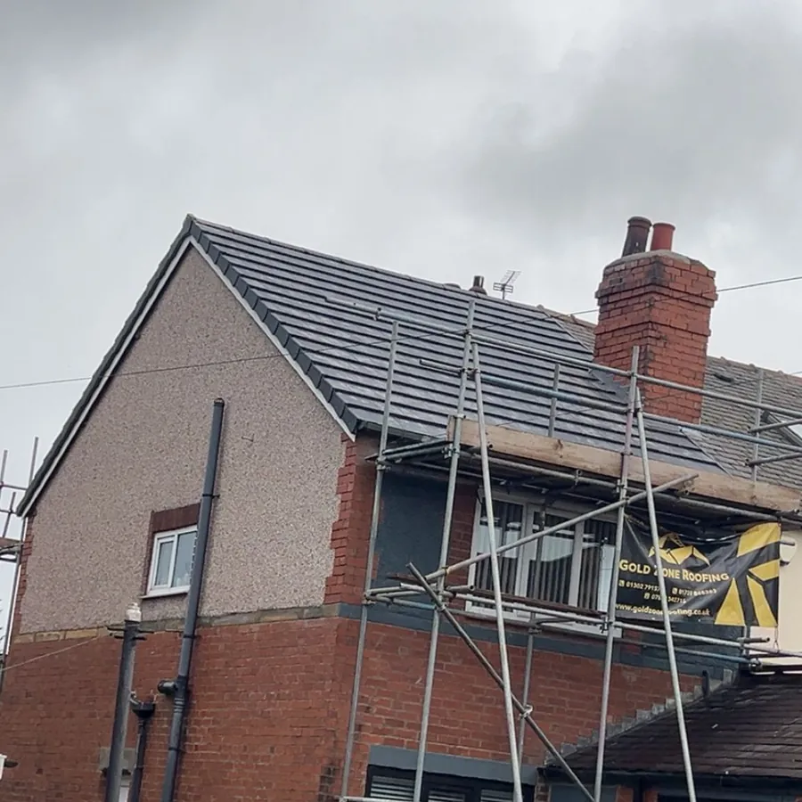 Semi re-roofed in grey tiles, scaffold still up