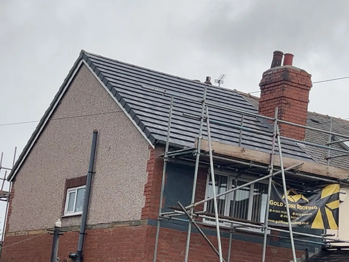 Semi re-roofed in grey tiles, scaffold still up