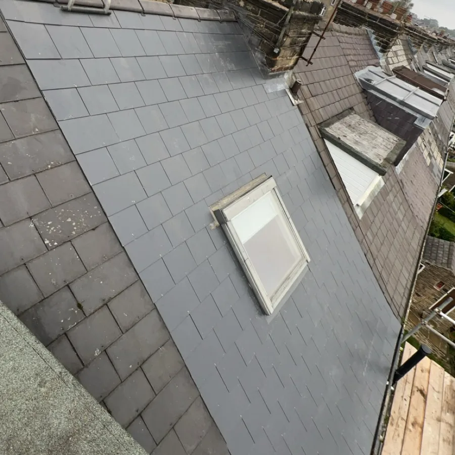 Roof window set back into a newly slated roof